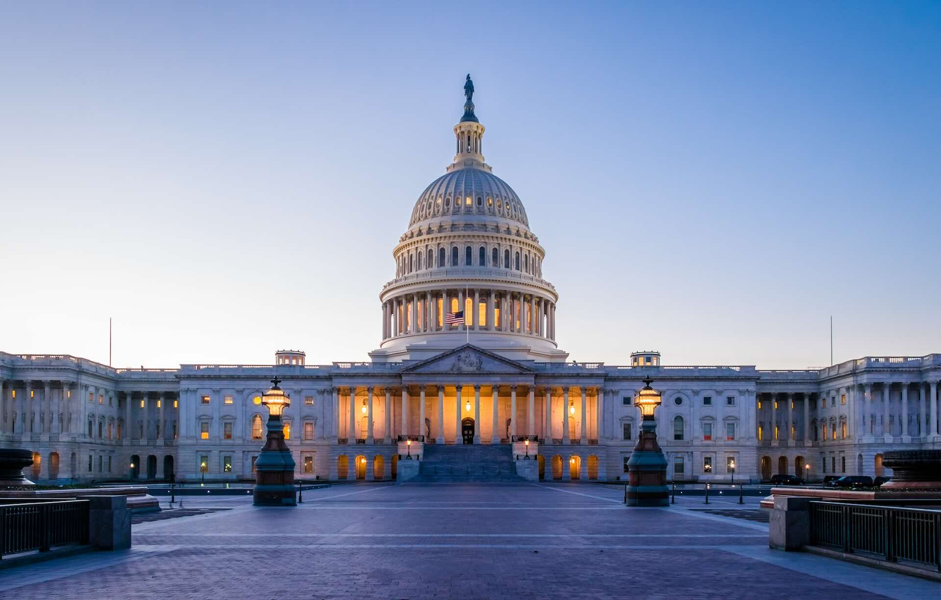 The US Capitol Building with a clear blue sky behind it.