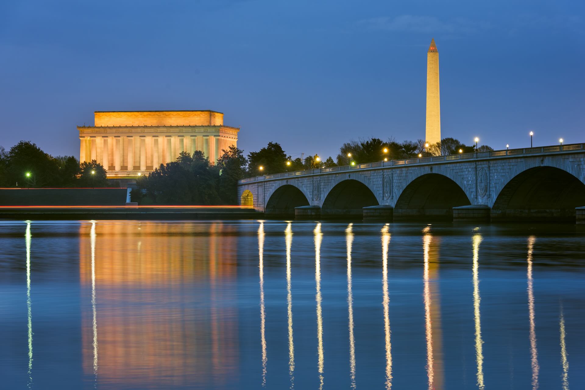 Washington DC, USA skyline on the Potomac River with Lincoln Memorial, Washington Monument, and Arlington Memorial Bridge.